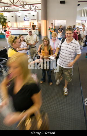 La gente in attesa nella Hall (sala d'attesa) e prepararsi a bordo del velivolo al terminal di un aeroporto Foto Stock