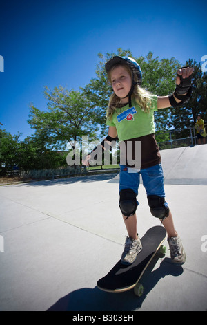 Ragazza con lo skateboard in Skate Park Foto Stock