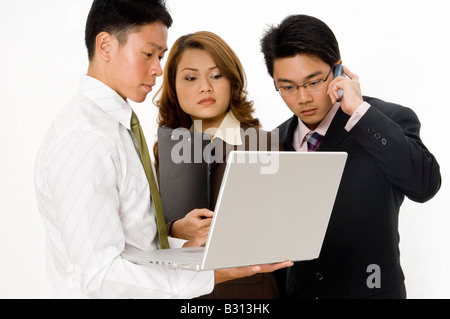 Un gruppo di tre giovani professionisti hanno una improvvisata riunione aziendale Foto Stock