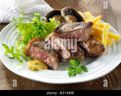 Lombata di carne di manzo e una fresca insalata mista e patatine Foto Stock