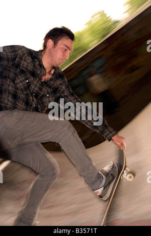 22 anni di skate maschio boarder in azione a skate park London REGNO UNITO Foto Stock