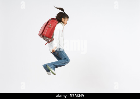 Schoolgirl jumping Foto Stock