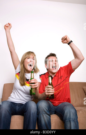 Gli appassionati di calcio guardando la partita di calcio in televisione Foto Stock