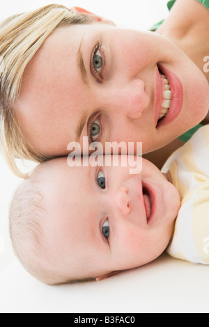 La madre e il Bambino giacente sul piano sorridente Foto Stock
