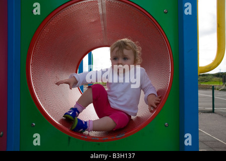 Ardara County Donegal Irlanda 23 mese old toddler bambina gioca su un telaio di arrampicata in un parco giochi Foto Stock