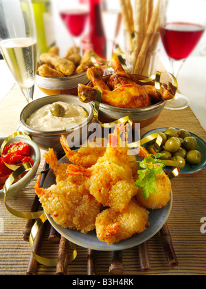 Parte di cibo a buffet con grissini, fritte Gamberi panati, le olive verdi, marinato pomodori seccati al sole, pollo BBQ Foto Stock