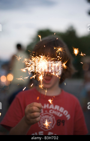 Chiusura del bambino tenendo un sparkler bruciore, luglio quarta, celebrazione Foto Stock