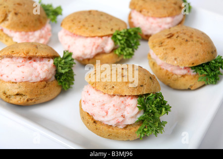 Una purea di gamberi ripieno di carne in piccoli marrone crostini di pane su una piastra Foto Stock