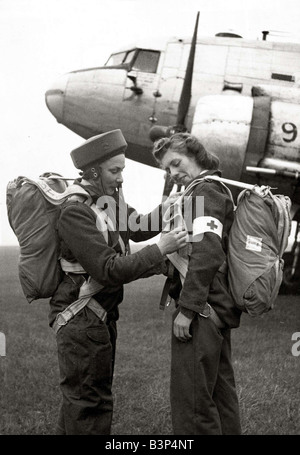 Due membri del Flying sorelle un nuovo volo British unità infermieristica preparare i loro paracadute prima di salire a bordo del piano per una missione a sinistra è responsabile della sezione di Audrey Penny penfold controllare il cablaggio di Suor Craig s parachute 1946 circa Foto Stock