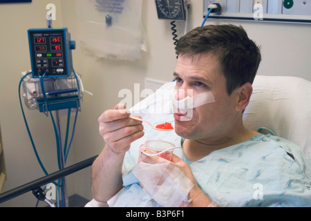 L'uomo mangiare red jella durante il recupero dalla chirurgia septoplasy Foto Stock