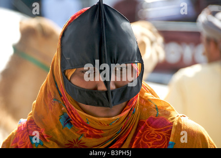 Close up beduino donna vestita di nero e arancio burka Sinaw Regione Sharqiya Sultanato di Oman Foto Stock