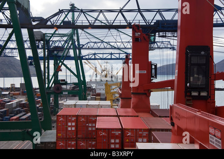 Navi e gru in un terminale per contenitori come si vede dal ponte di una nave portacontainer. Foto Stock