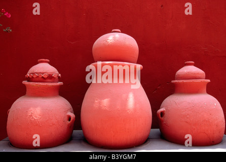 Bouganvillea e dipinta di vasi di terra decorare un cortile giardino nella Chiesa e Monastero di San Francisco nel centro di Lima, Perù. Il monastero è famosa per le sue catacombe e biblioteca antica. Foto Stock