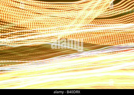 Abstract luce incandescente sentieri in una golden tonalità gialla Foto Stock