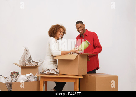 African giovane disimballaggio contenitori per il trasloco Foto Stock
