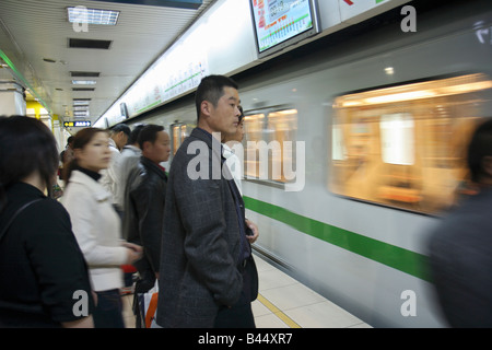 I passeggeri in attesa presso la stazione della metropolitana di Shanghai, Cina Foto Stock