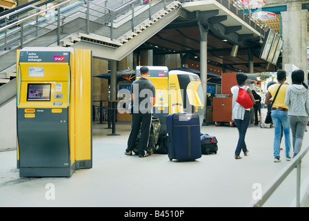 Parigi Francia, stazione ferroviaria "Gare du Nord" uomo che acquista il biglietto del treno dal computer Vending Machine all'interno, biglietto sncf Foto Stock