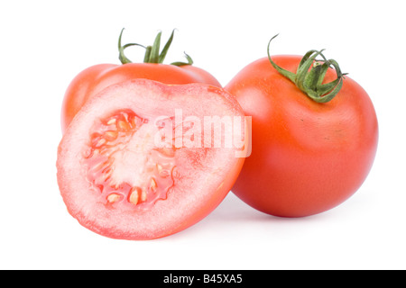 Pomodori maturi isolati su uno sfondo bianco con uno tagliati a metà Foto Stock