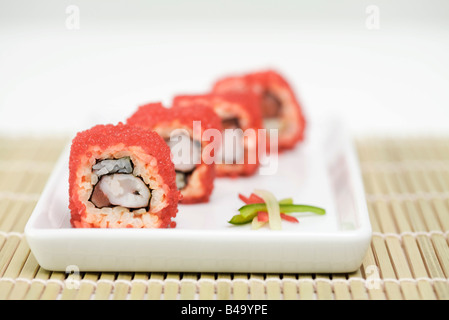 Maki sushi arrotolato in rosso flying fish roe, vista in sezione Foto Stock