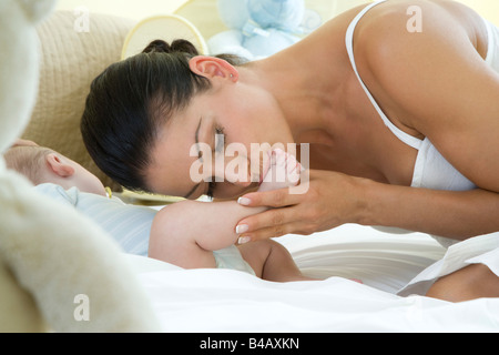 Baciare la madre del bambino in piedi Foto Stock