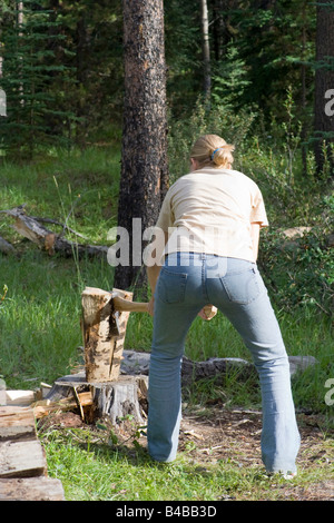 Giovane donna di trinciatura di legno - Parco Nazionale di Jasper, montagne rocciose canadesi Foto Stock