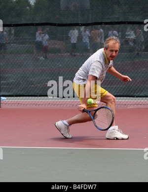 Medio-età uomo giocando a tennis Foto Stock
