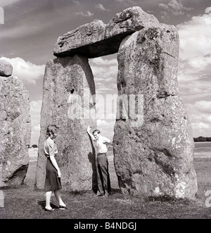 Uno di Gran Bretagna s più famosi e misteriosi monumenti antichi di Stonehenge sulla Piana di Salisbury Wiltshire una coppia giovane guardare il monumento dove Druid pellegrini venuti per adorare durante l'estate Solstic Foto Stock