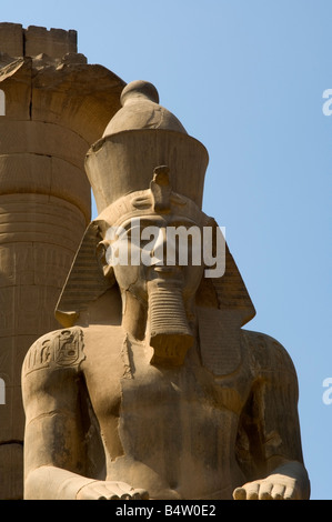 Seduto colossale statua di Ramses II, Tempio di Luxor, Sito Patrimonio Mondiale dell'UNESCO, Luxor, Egitto Foto Stock