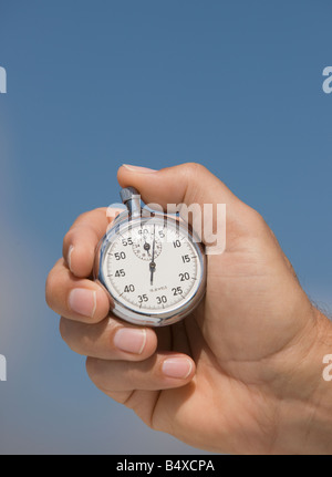 Stretta di mano azienda cronometro Foto Stock