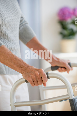 Senior donna utilizzando walker Foto Stock