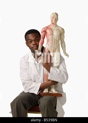 African chiropratico azienda modello anatomico Foto Stock