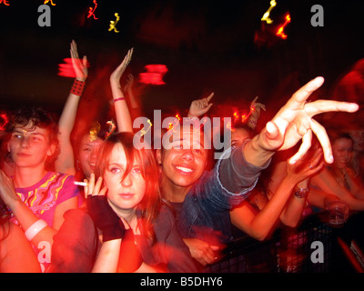 Gli appassionati di musica go crazy sventolare le mani in aria per la loro band preferita in quanto tengono allo stadio Foto Stock