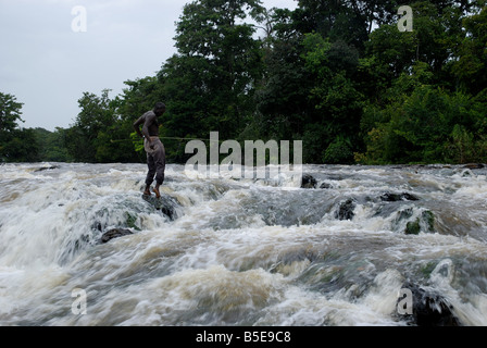 Uomo nero pesca in bianco tempestosa wild water Tapanahoni fiume Suriname Foto Stock