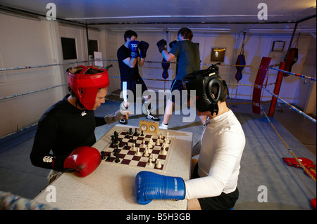 I concorrenti si affrontano in turni alternati in anello e sulla scheda in un nuovo sport noto come chess boxing Foto Stock