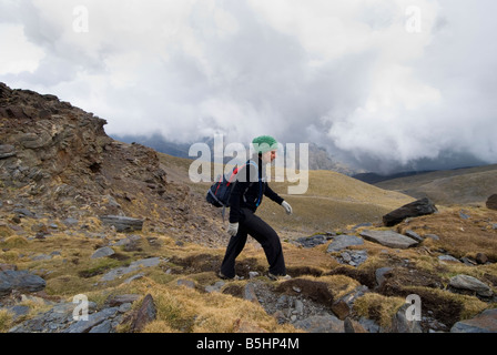 Woman trekking fino a Siete Lagunas nelle montagne della Sierra Nevada, Andalusia nel sud della Spagna Foto Stock