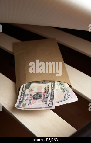 Borra di noi 50 dollar note di contanti in una busta ripiene sotto il materasso di un letto Foto Stock