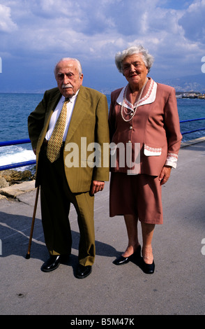 Una coppia di anziani, elegantemente vestito in abiti che sembra a partire dagli anni cinquanta, pausa lungo di Beirut Corniche. Foto Stock