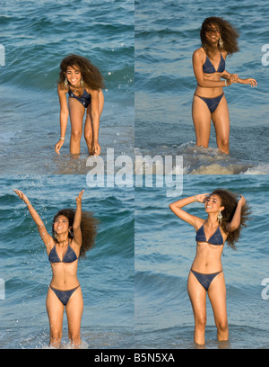 Giovane donna in bikini gioca in acqua Foto Stock
