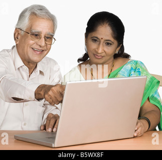 Senior di uomo e di una donna matura al lavoro su un notebook Foto Stock