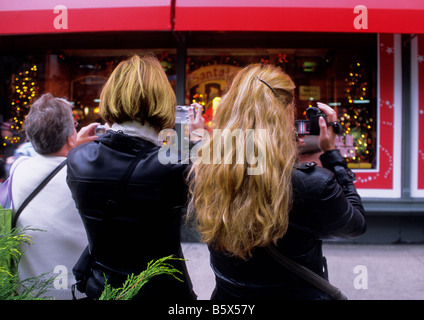 New York City il magazzino Macy's tre persone Window Shopping e fotografare la finestra di visualizzazione USA Foto Stock