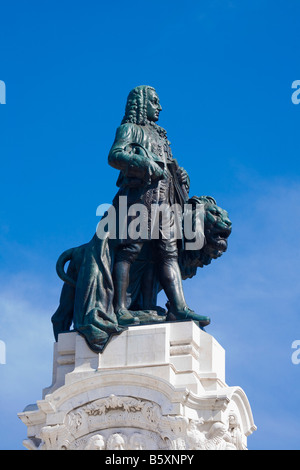 Tall statue of the Marquis of Pombal standing by a lion in Marquis of Pombal Square Lisbon, Portugal Stock Photo