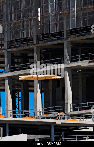 Costruzione / Un cantiere Crane solleva un carico di legname sopra un alto progetto di costruzione a Melbourne Victoria Australia. Foto Stock