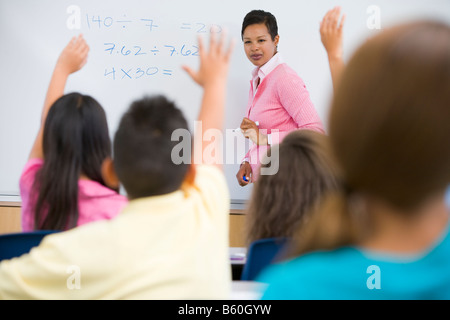 Gli studenti nella classe di volontariato per insegnante al bordo anteriore (messa a fuoco selettiva) Foto Stock