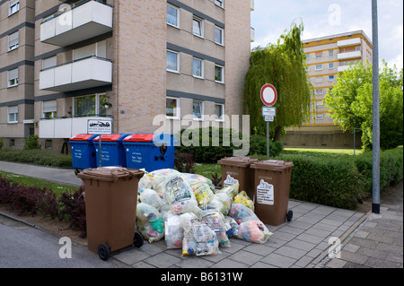 Il riciclaggio in Germania, giallo e sacchetti di rifiuti di carta nella parte anteriore dei blocchi di appartamenti Foto Stock