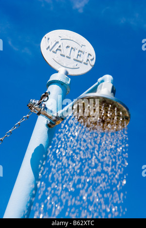 Basso angolo vista di spruzzatura di acqua da una doccia spiaggia, Miami Beach, Florida, Stati Uniti d'America Foto Stock