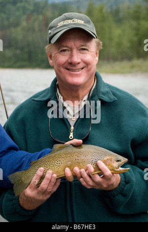 Mickey Ryan con una mosca (catturato e rilasciato) Westslope Tagliagole trota di fiume Elk, nella parte orientale del British Columbia, Canada. Foto Stock