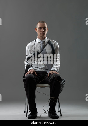 Imprenditore su una sedia Foto Stock