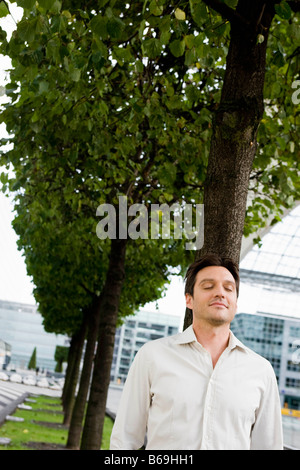 Uomo che cammina lungo gli occhi chiusi Foto Stock