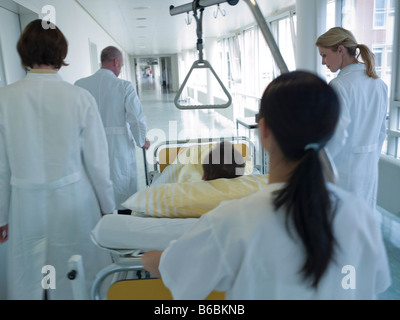 Infermiera femmina spingendo il paziente sulla barella Foto Stock