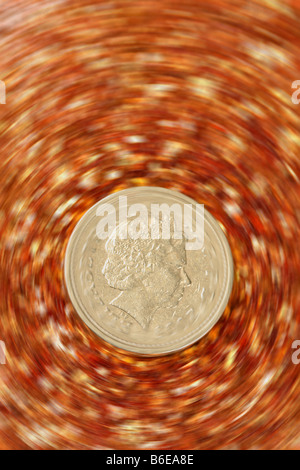 £ 1 una libbra di moneta in una spin finanziario con oro glitter sfondo Foto Stock
